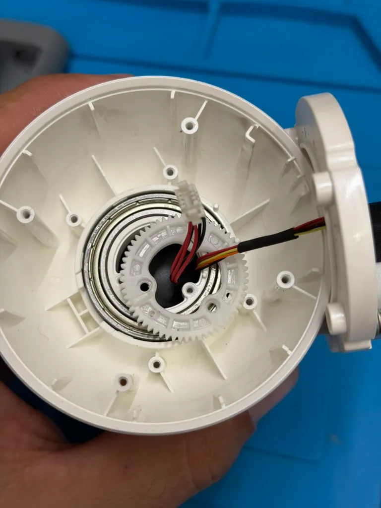 Cracking the base open: the pan/tilt gear ring and the motor ribbon