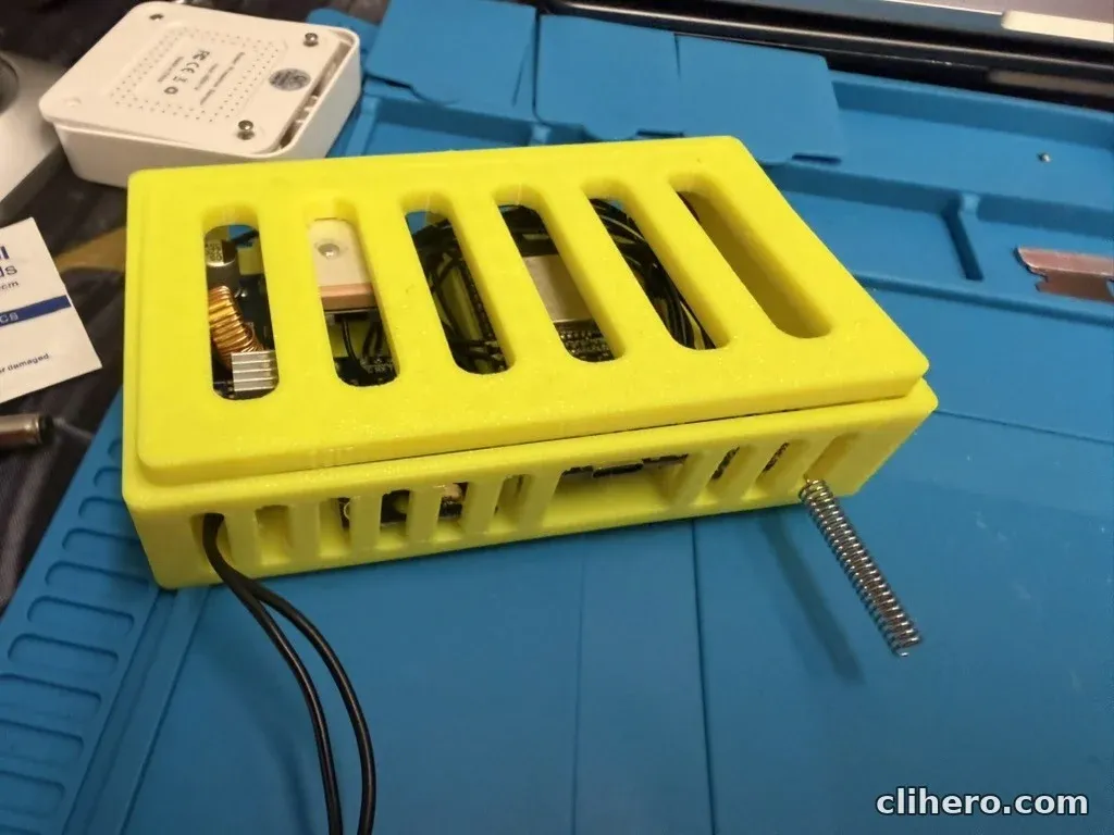 The case with the 12 V lead coming out of one end and the spring antenna sticking out of the corner