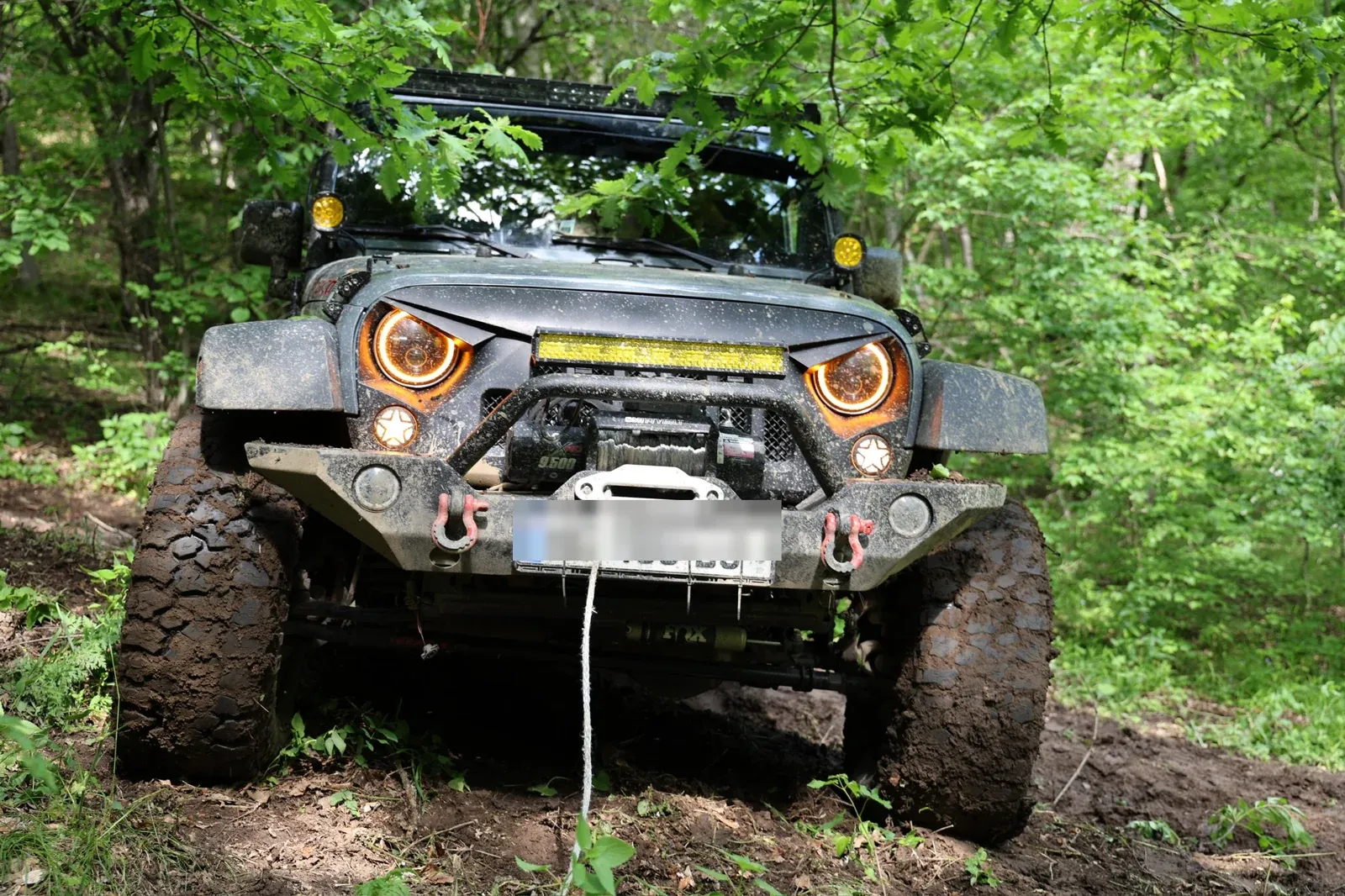 My Wrangler on a muddy forest trail in Georgia