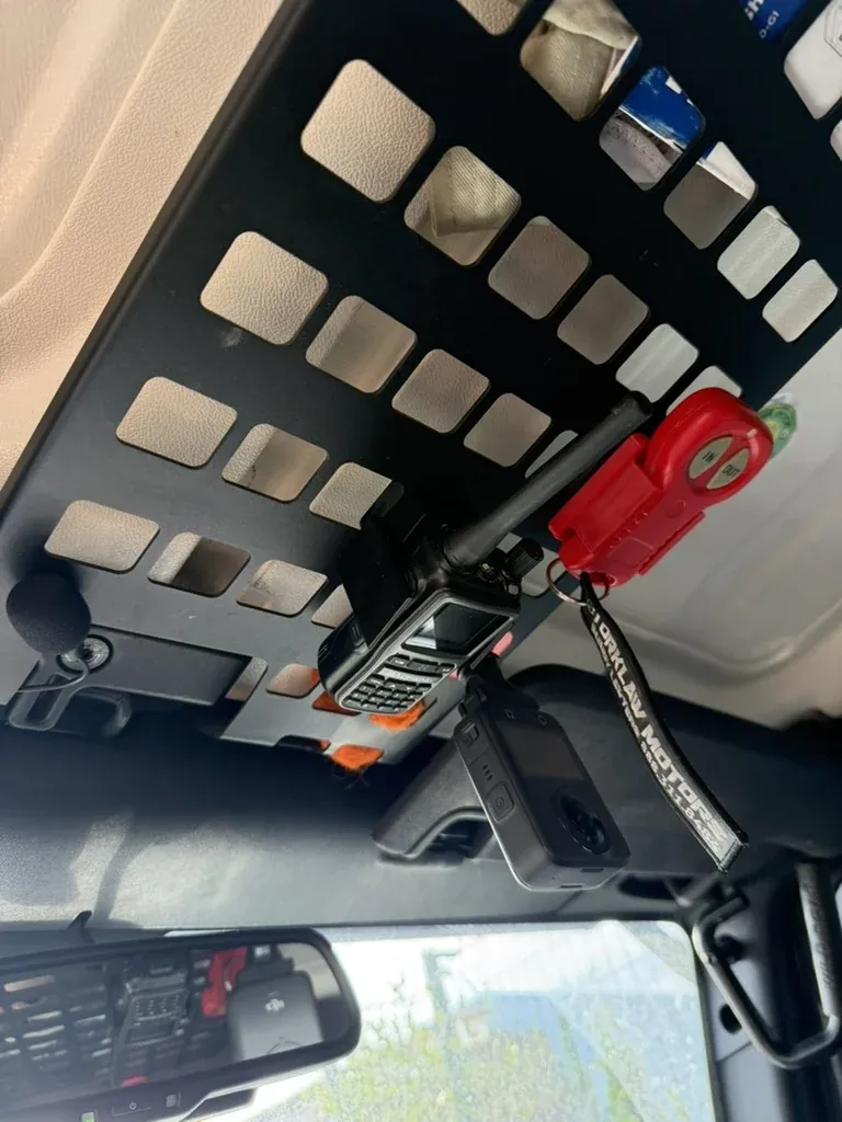 The overhead MOLLE panel with the radio and an action camera mounted